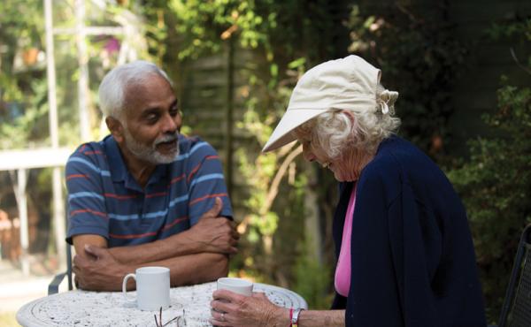 Couple laughing and talking in a garden