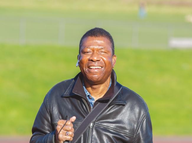Man facing camera with grass in the background