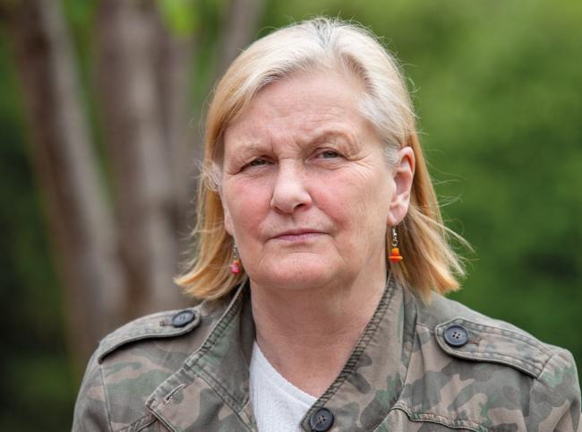 Headshot of woman with green garden background