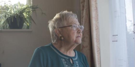 Worried woman looking out of window